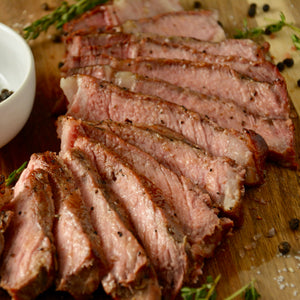 medium rare ribeye steak cooked perfectly on cinder grill 